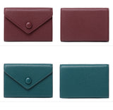 Two maroon and two teal leather travel wallet card holder